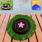 Solar-powered floating fountain pump with green leaf base and pink star nozzle on pond water