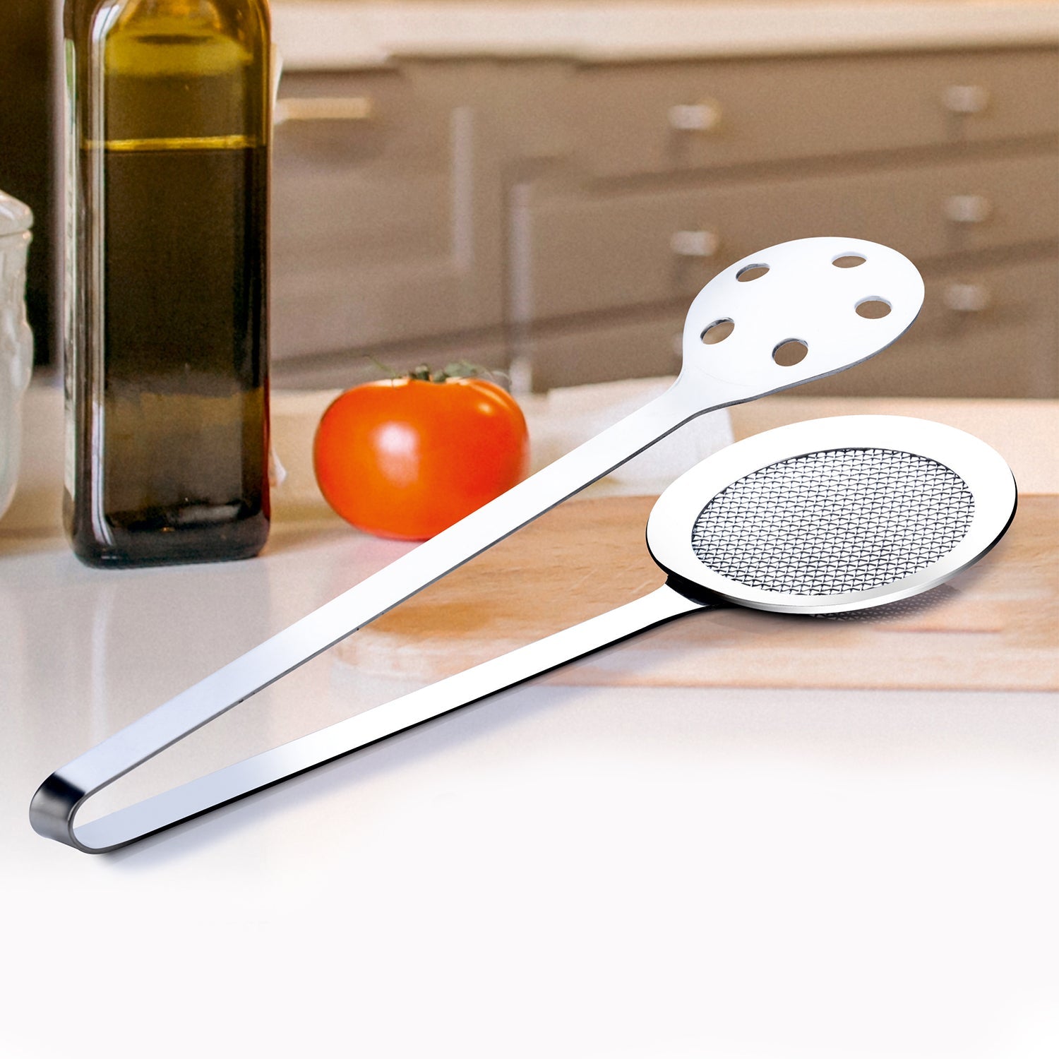 Stainless steel skimmer serving tong with fine wire mesh and perforated tong sides for kitchen use