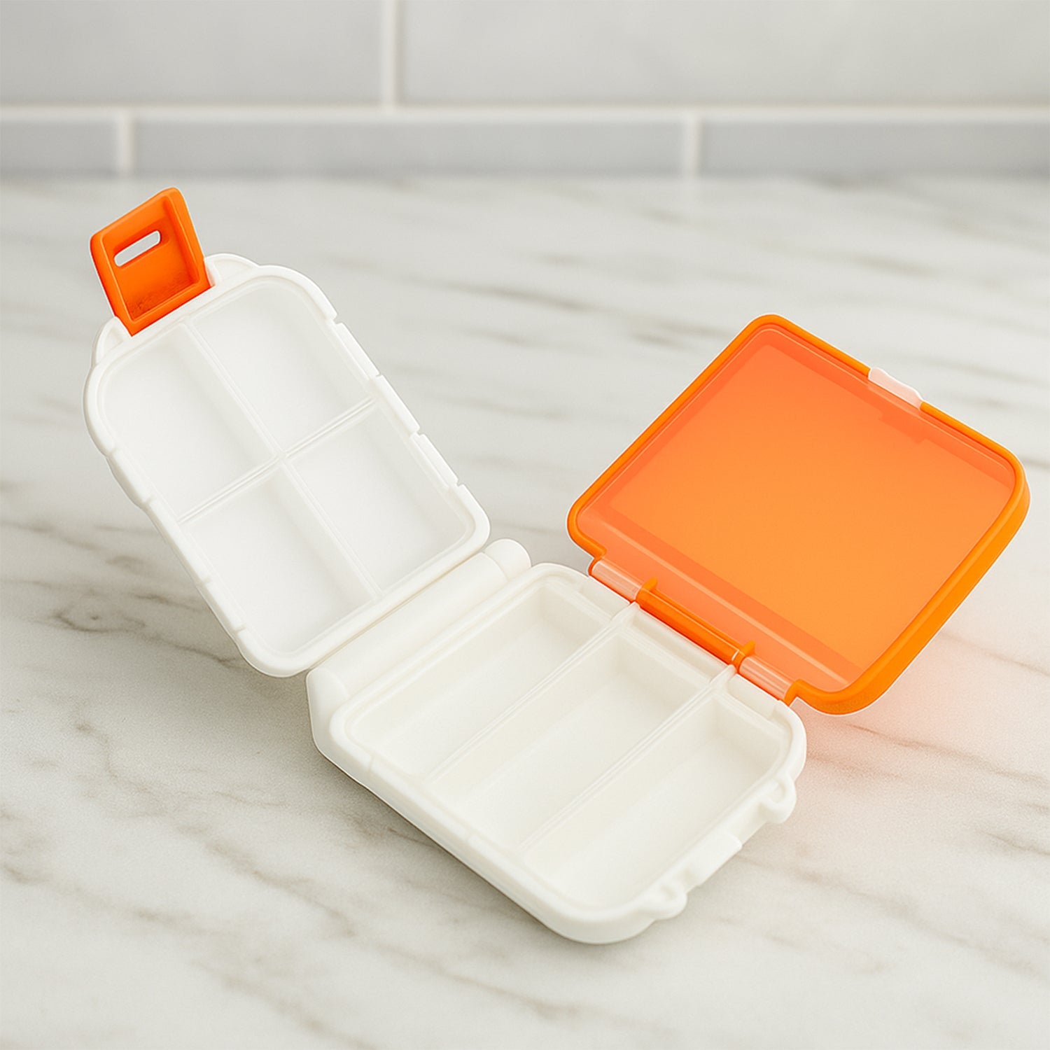 Portable orange dual-sided pill organizer box closed, showing compact design