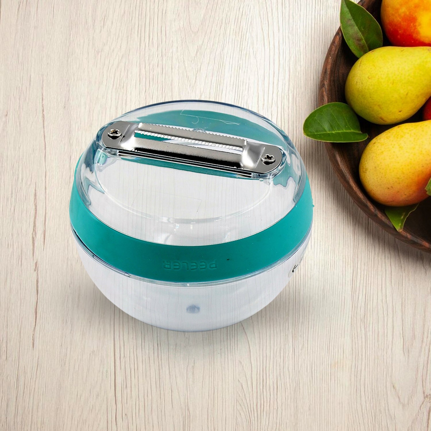 Side view of the round peeler highlighting its removable peel-catching container.