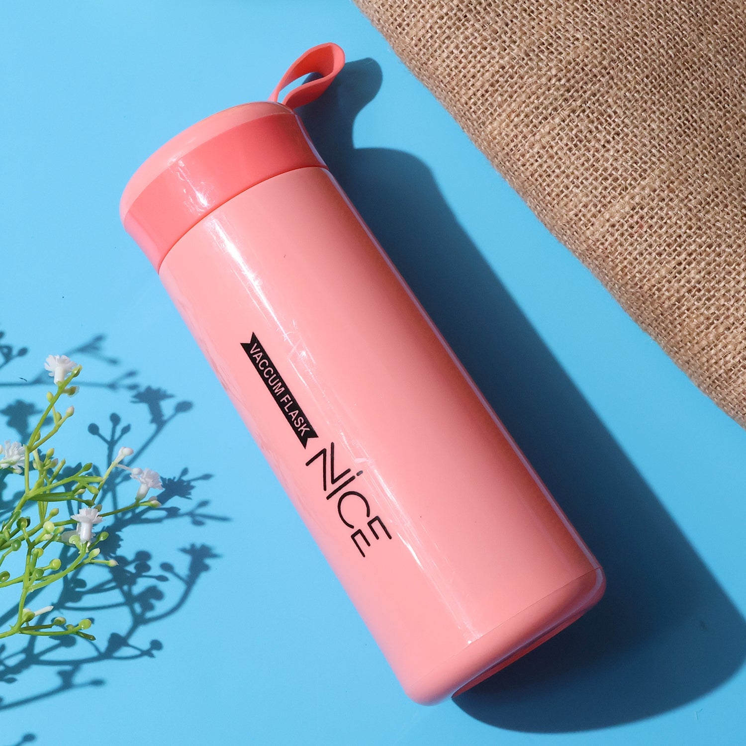 Portable pink plastic water bottle with convenient carry strap