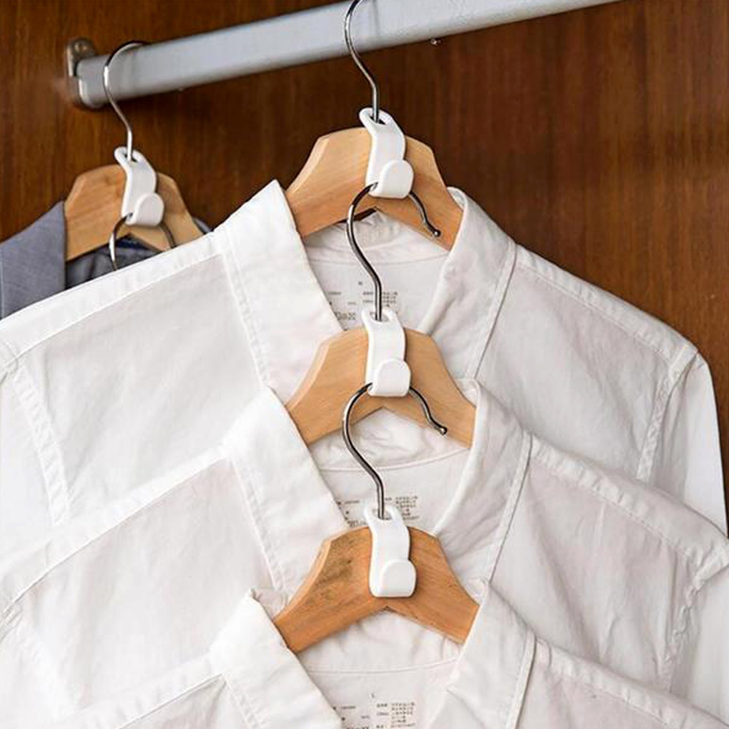 Hanger connector hook attached to a clothes hanger, demonstrating vertical storage.