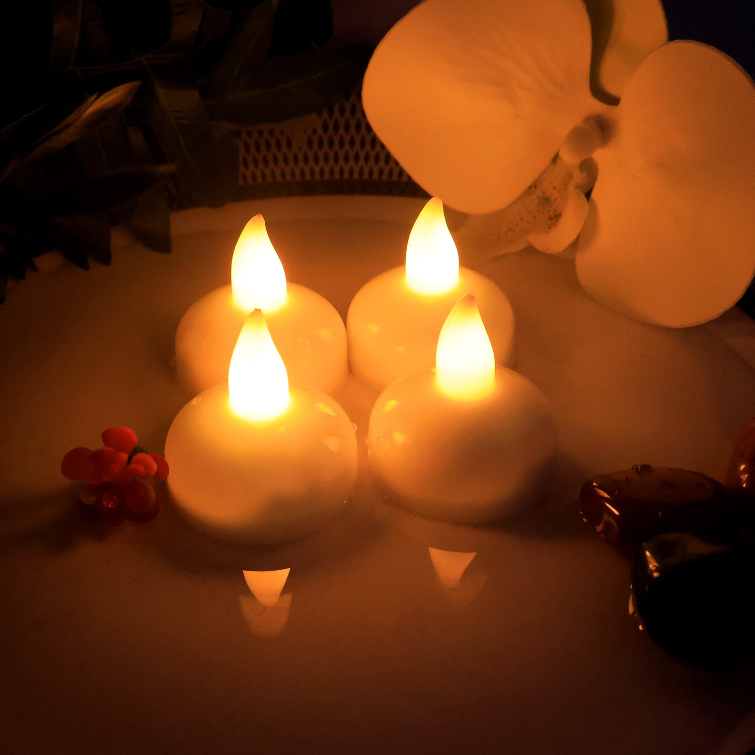 Decorative LED floating candles lit in water bowl creating festive ambiance