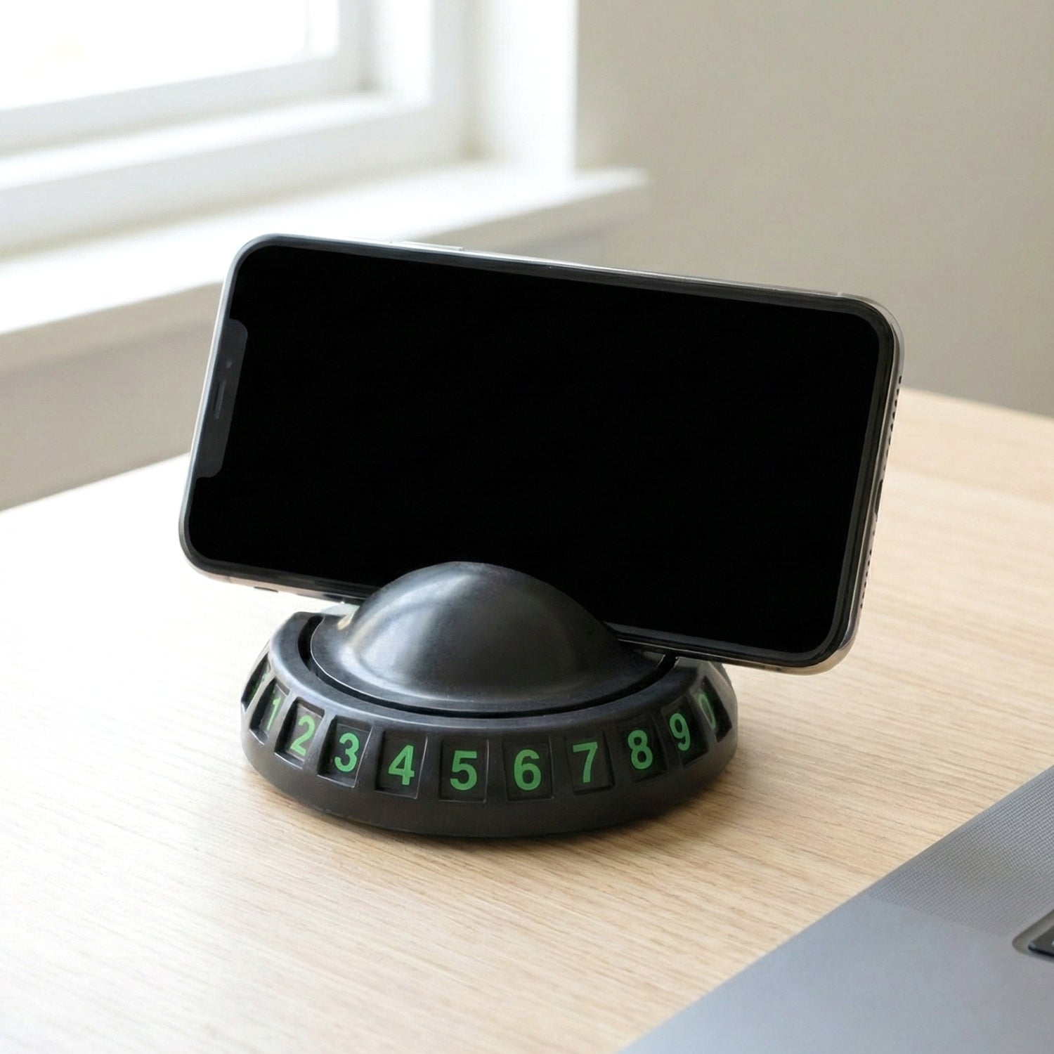Close-up view of car dashboard mobile holder with anti-slip base and parking number display