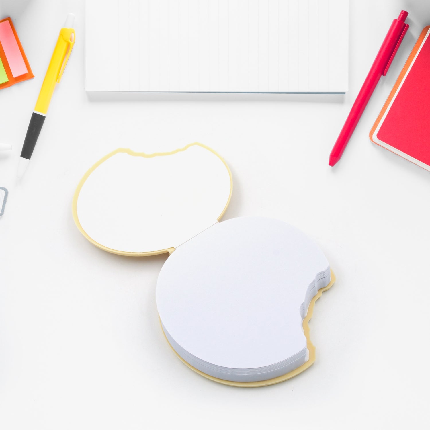 A stack of four round biscuit notebooks, highlighting their compact and uniform design.