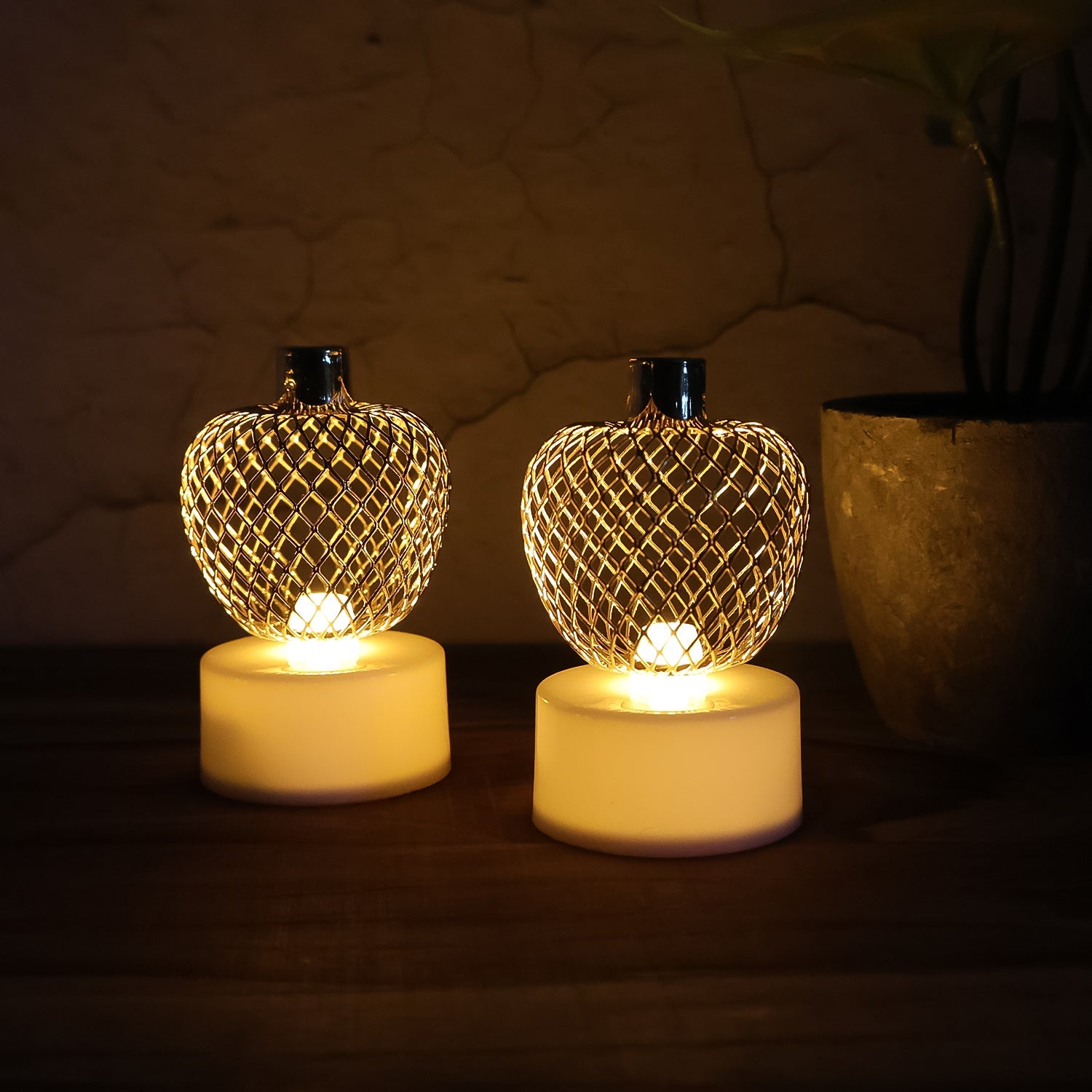 Three apple LED tealight candles creating a warm, ambient glow in a room.