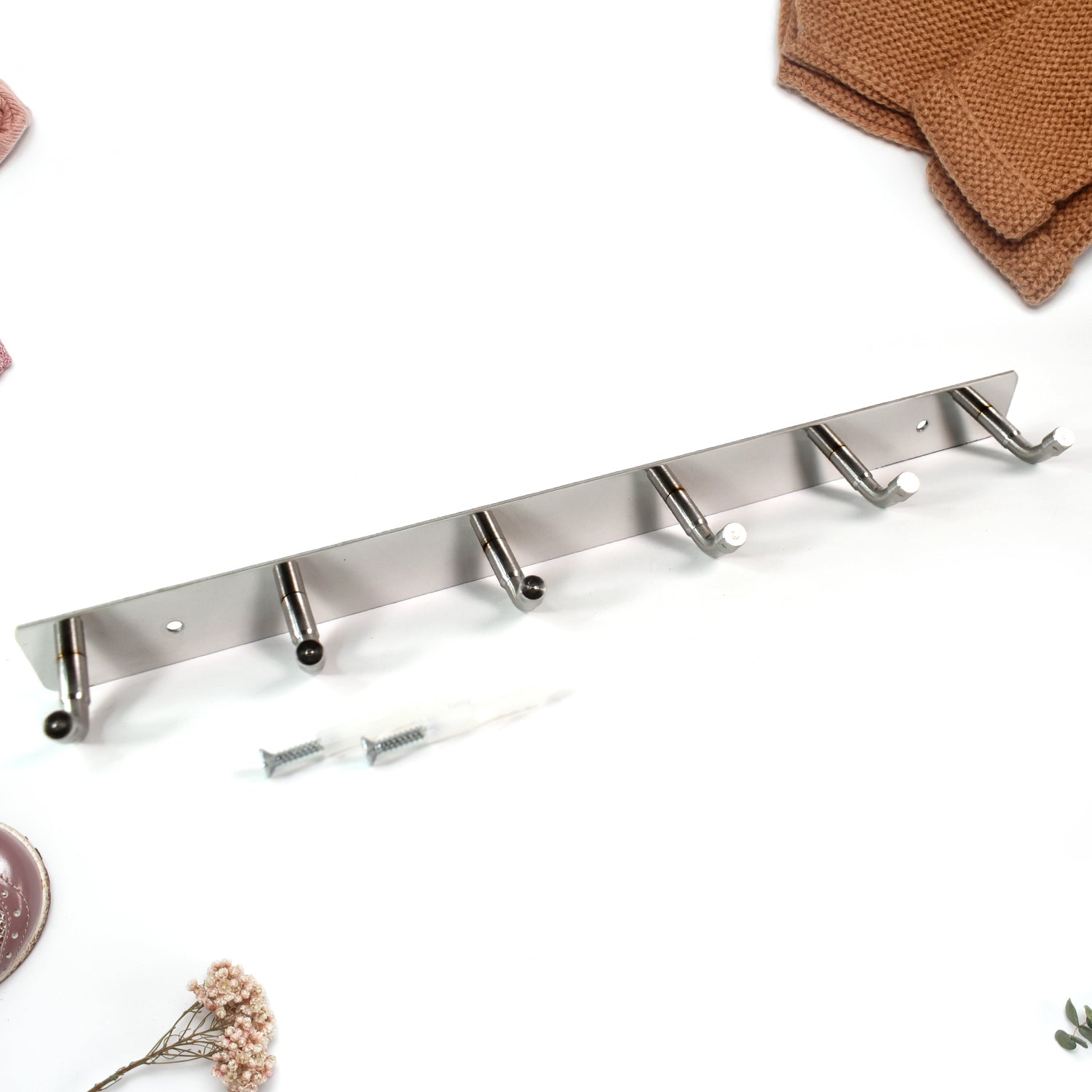 Close-up view of stainless steel hooks with smooth rounded edges on coat rack