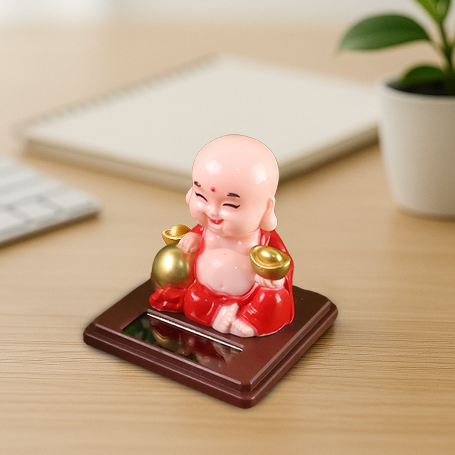 Solar Buddha Car Ornament placed on a car dashboard, adding a serene touch to the vehicle's interior.