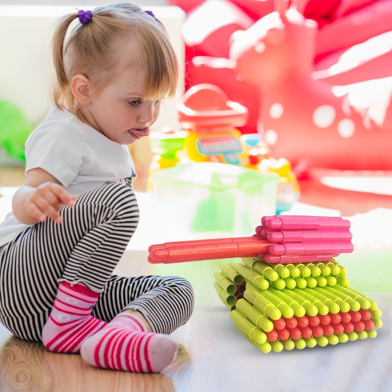 A child happily playing with the intelligent kids construction toy on the floor.