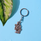 Front view of Radha Krishna metal keychain showing detailed spiritual motifs