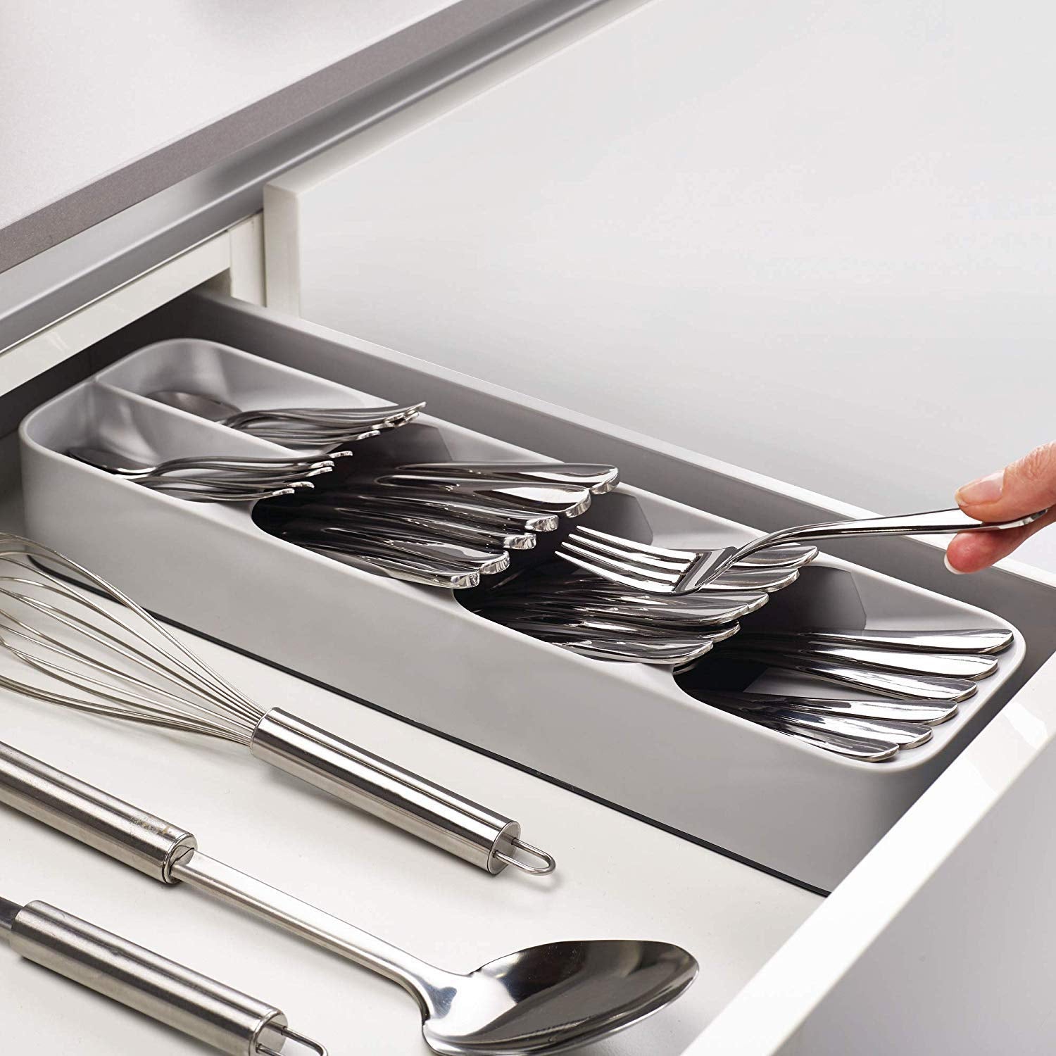 An empty, grey plastic cutlery tray with multiple compartments for kitchen drawer organisation.