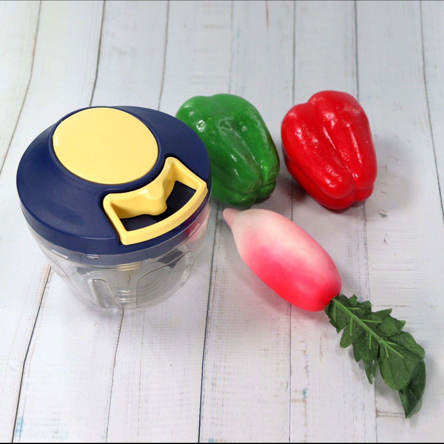 Chopper with its container and sharp stainless steel blades for vegetables.