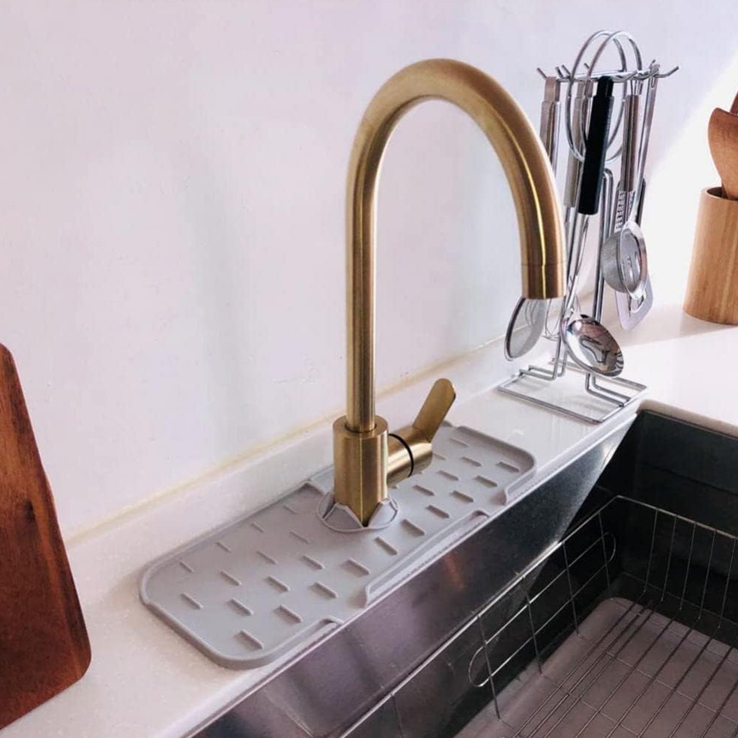 Bathroom countertop protected by a faucet drip tray, maintaining a clean and dry surface.