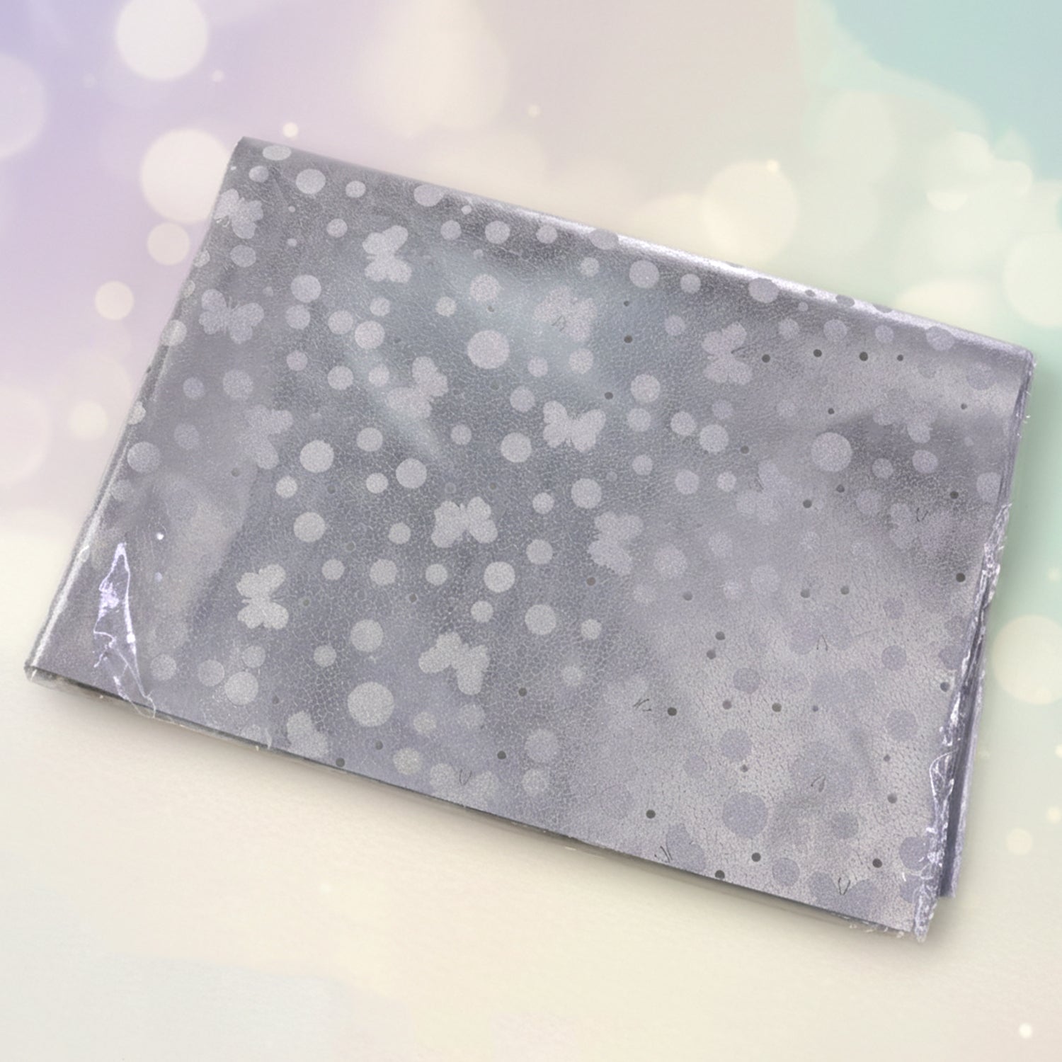 Polka dot pattern on silver luxury gift wrapping paper sheets