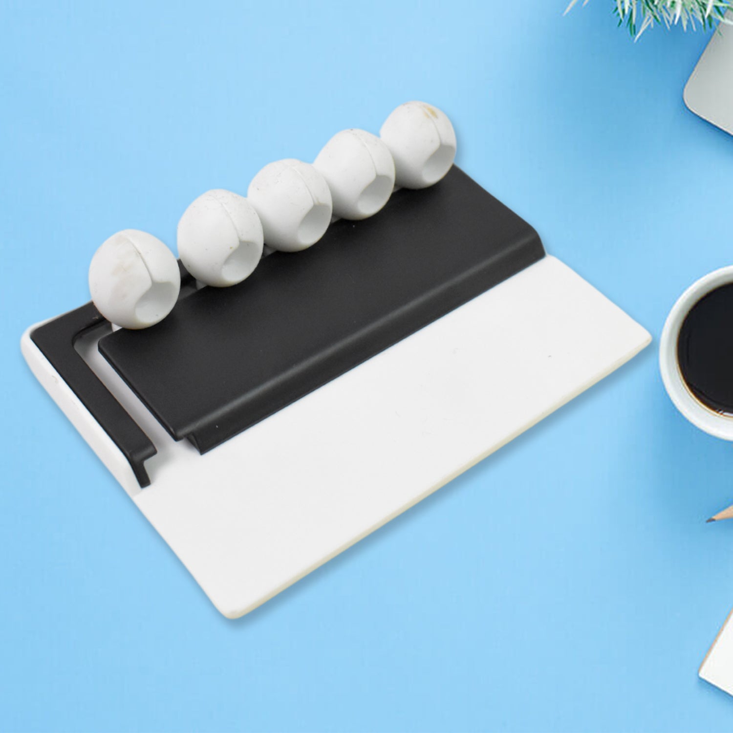 Cable holder neatly organizing USB and headphone cables