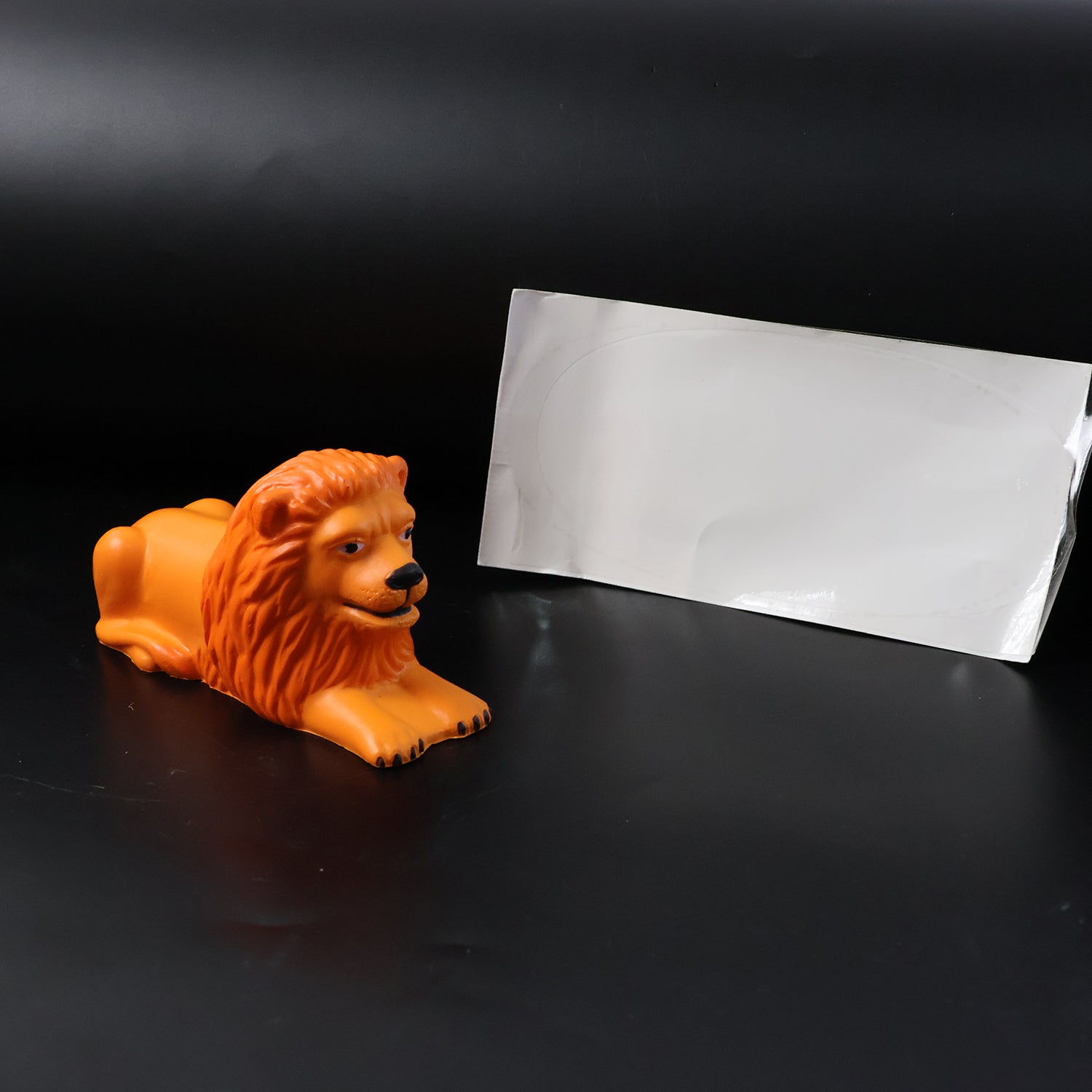 Decorative lion figurine with glossy orange-gold finish for car or office
