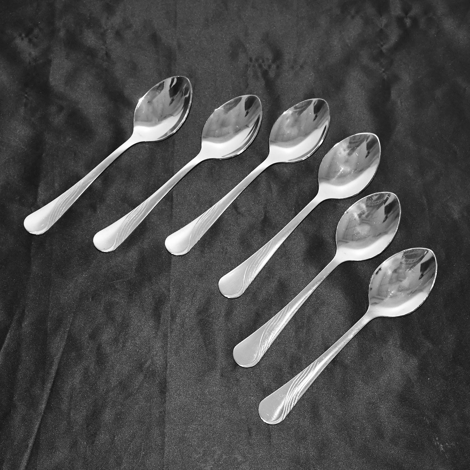 Close-up of elegant polished stainless steel dining spoons