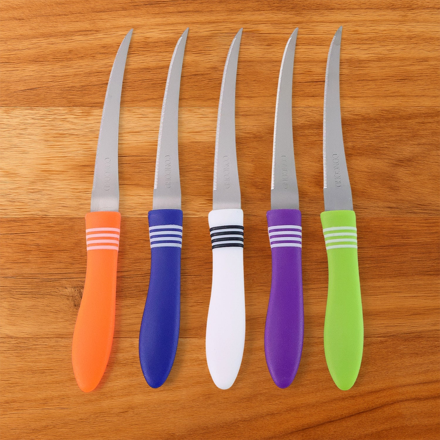 Serrated knife effortlessly slicing ripe tomato, showcasing sharpness.