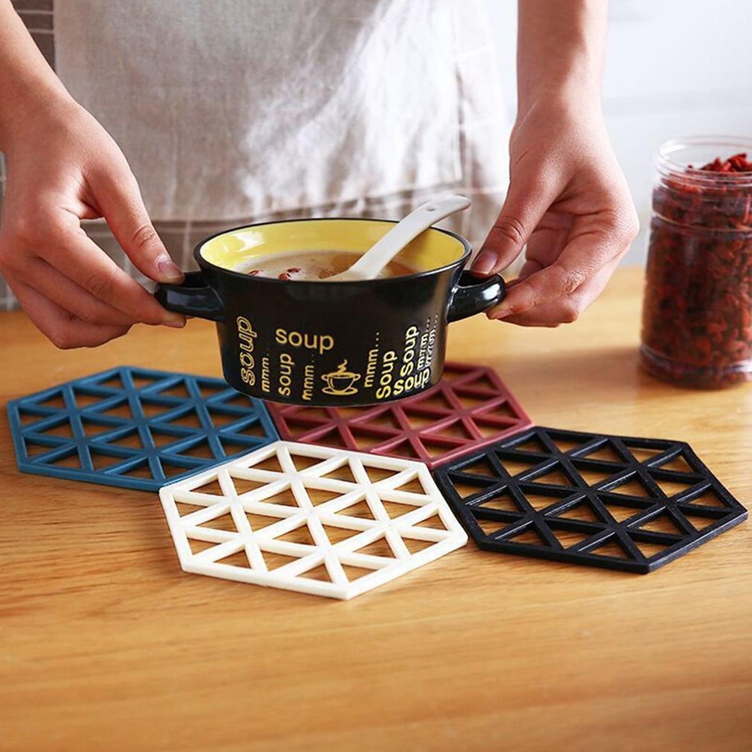 Black PVC tea coaster offering excellent heat insulation on a wooden table.