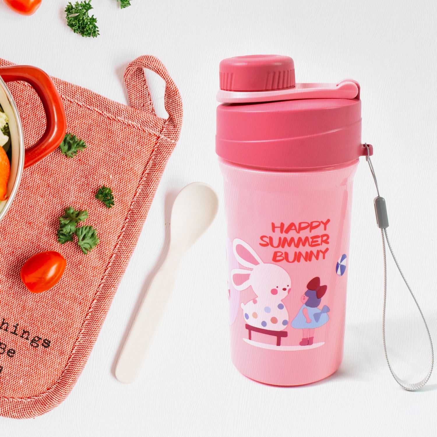 Overhead view of the complete lunch box set, including the reusable food container, bottle, and fork.