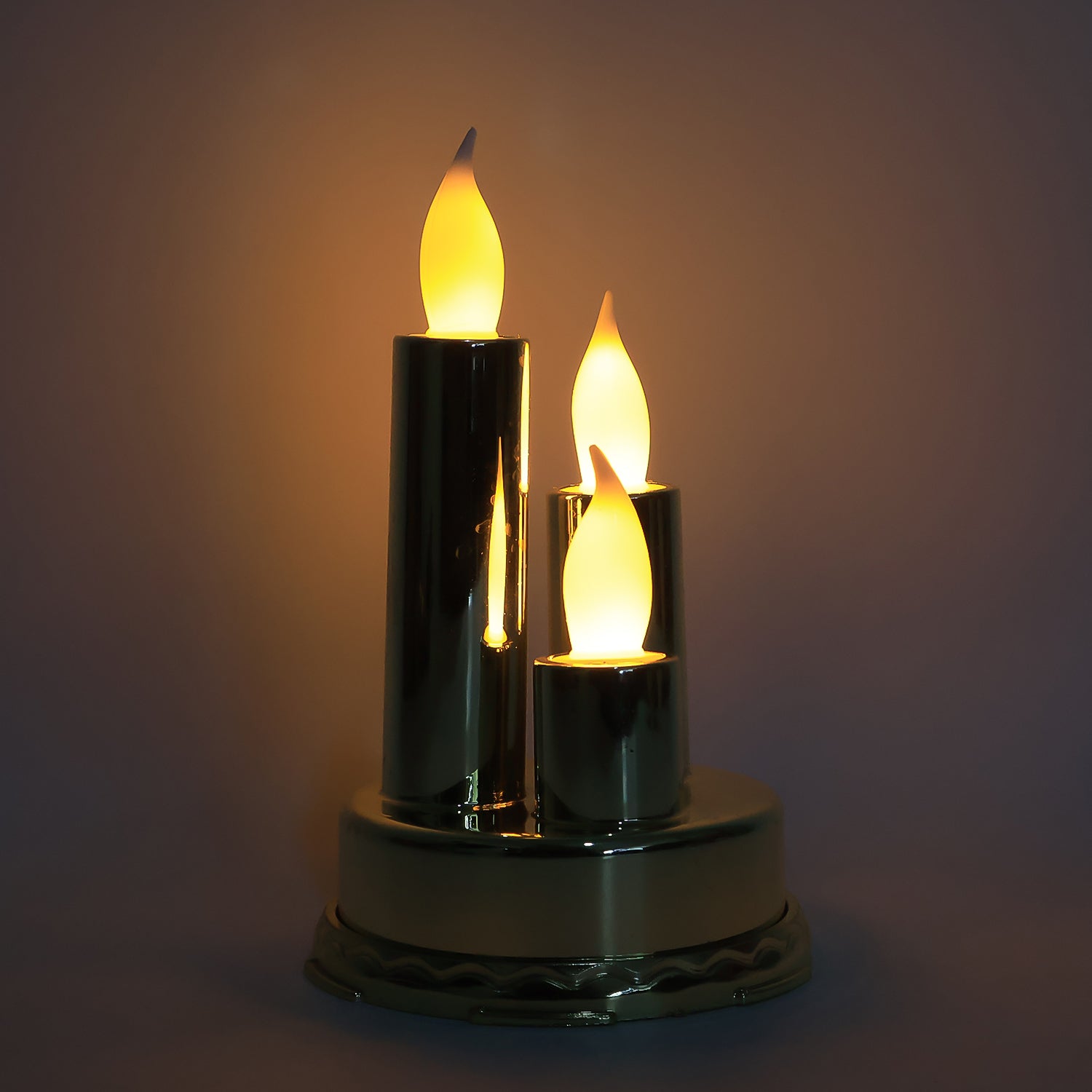Warm flickering LED lights on golden flameless candle lamp enhancing home décor
