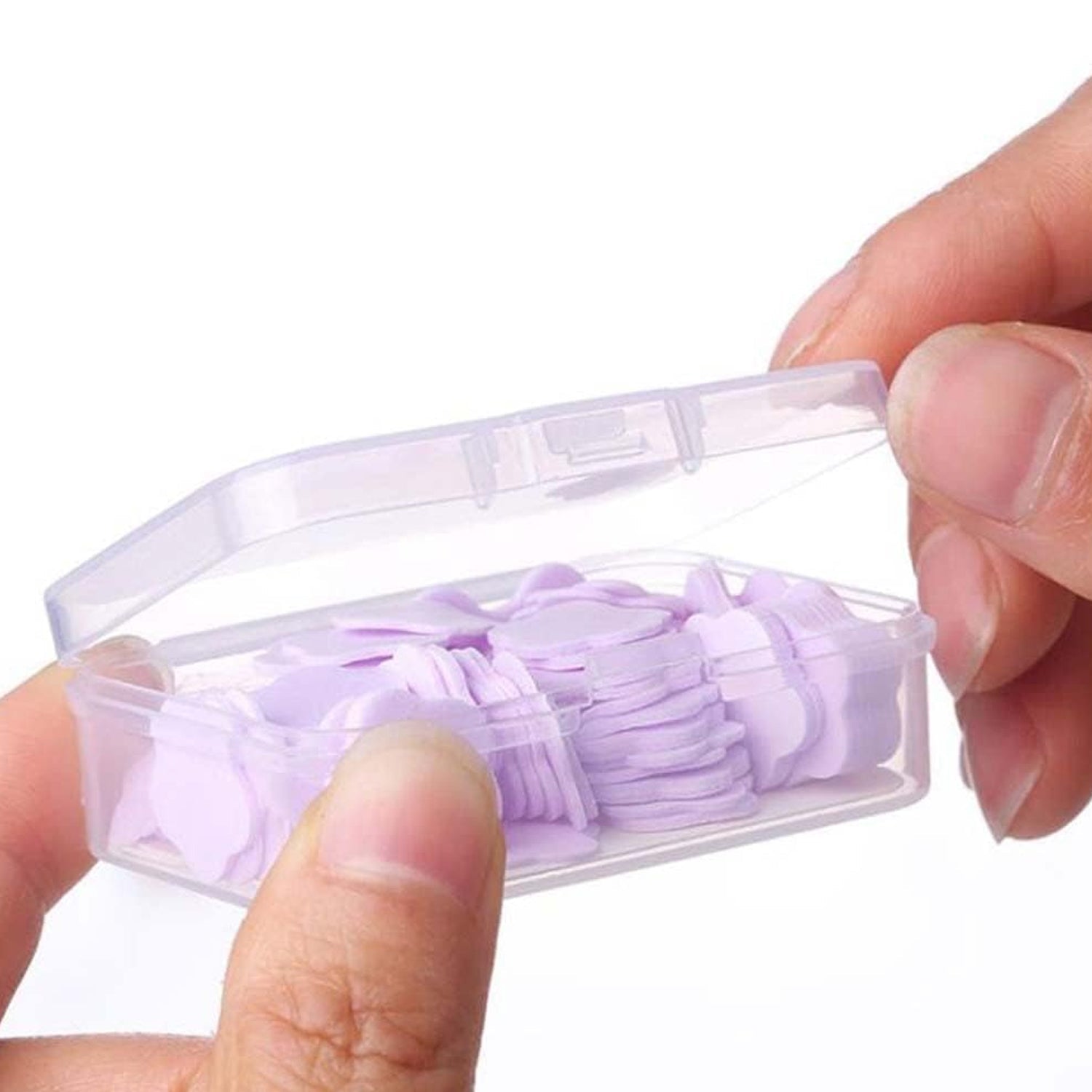 Hands lathering with a flower-shaped portable soap sheet, creating rich foam.