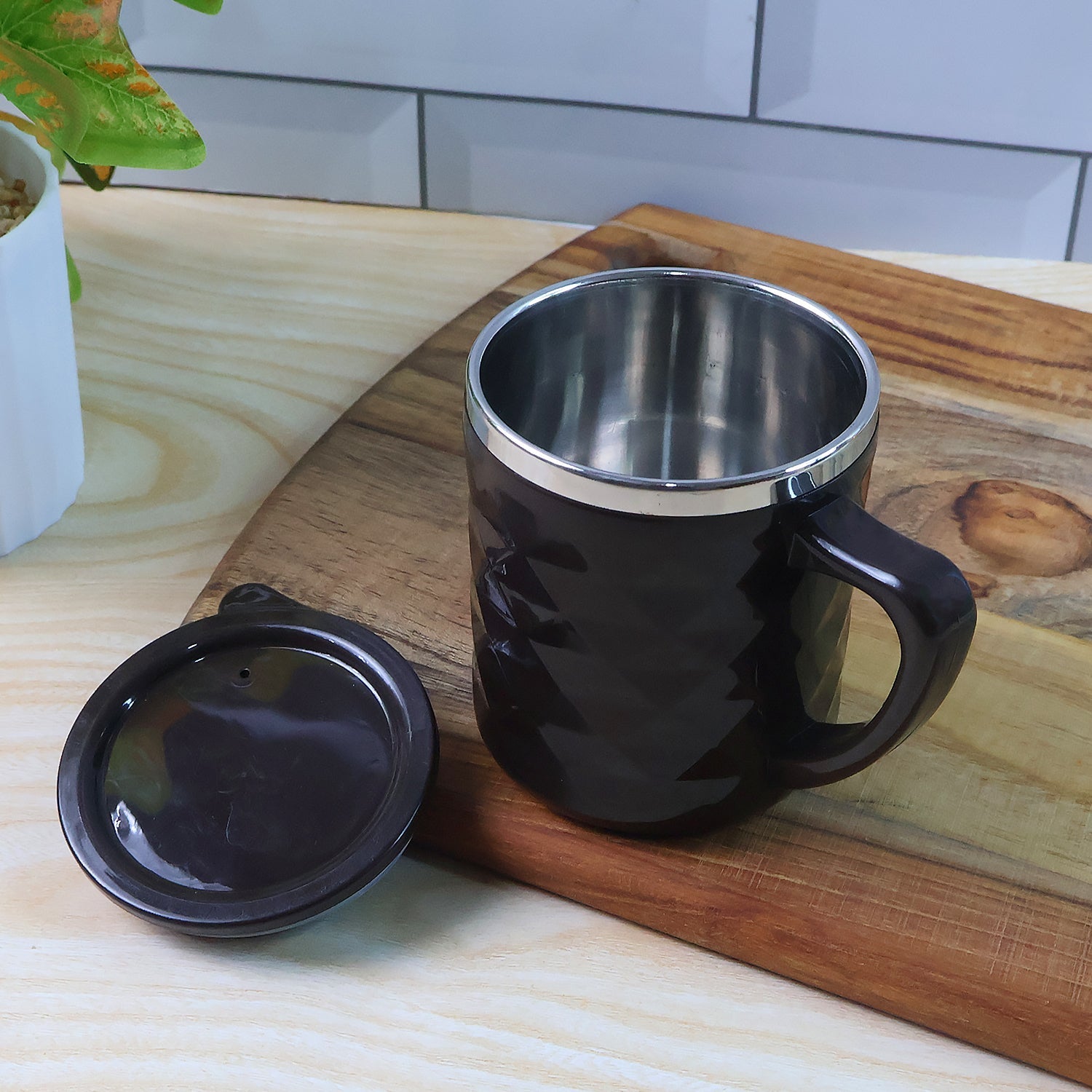 Top view of mug cup with leak-resistant push-fit lid in closed position