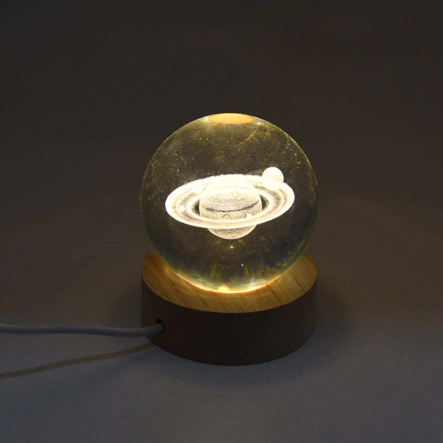 The astronaut 3D crystal lamp glowing softly, creating an ambient atmosphere.