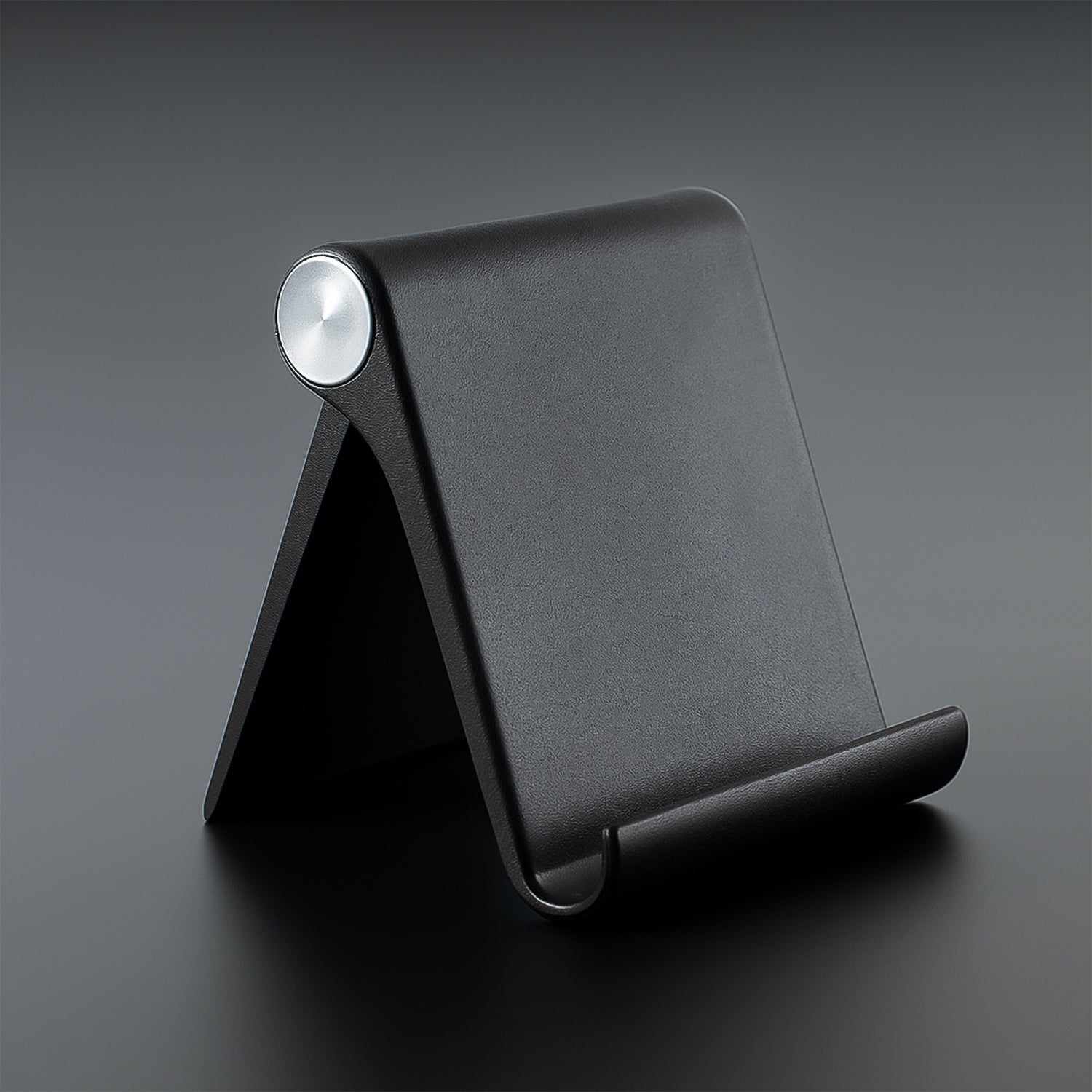 Foldable mobile stand showing adjustable angle on a study table