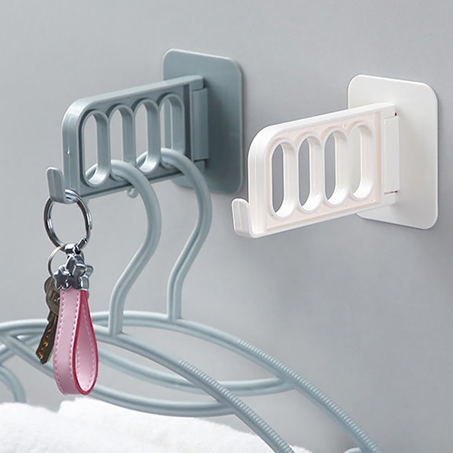 Single ABS plastic door hook for bathroom, kitchen, or bedroom storage.