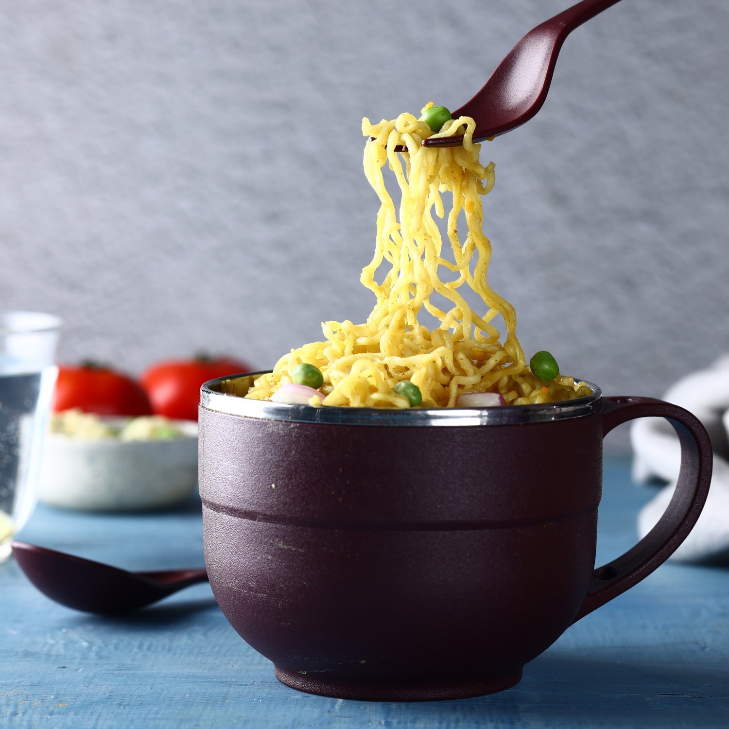 Ganesh brand insulated steel bowl with spoon and fork.