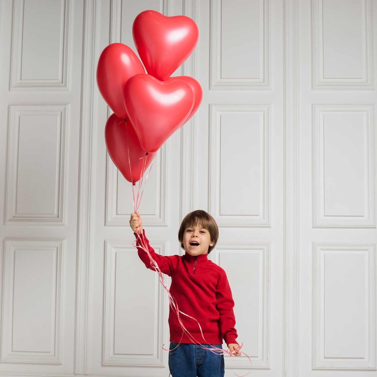 Various heart shaped latex balloons in different colors floating gently for decoration.