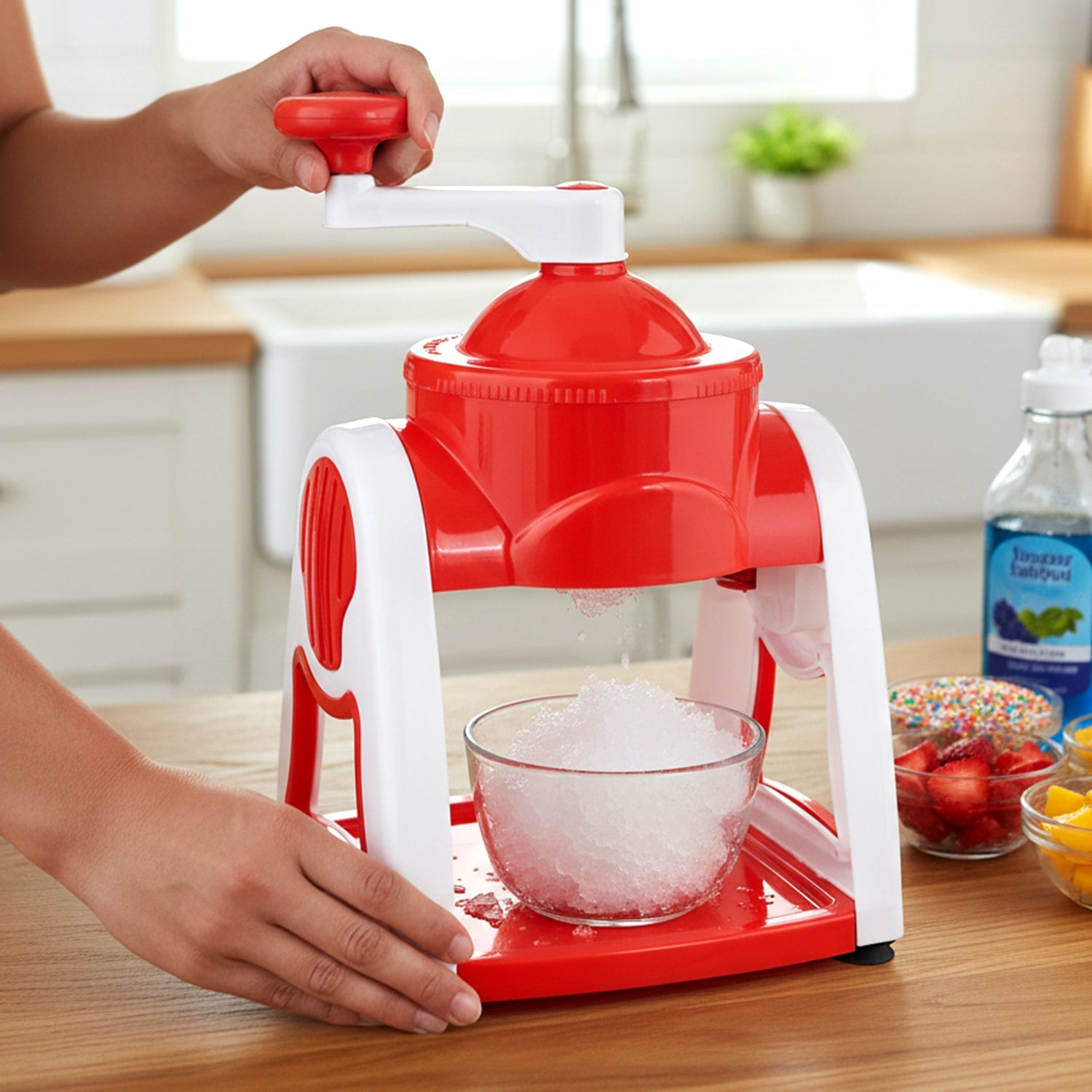 Red manual ice crusher machine on a kitchen counter, showcasing its compact design.