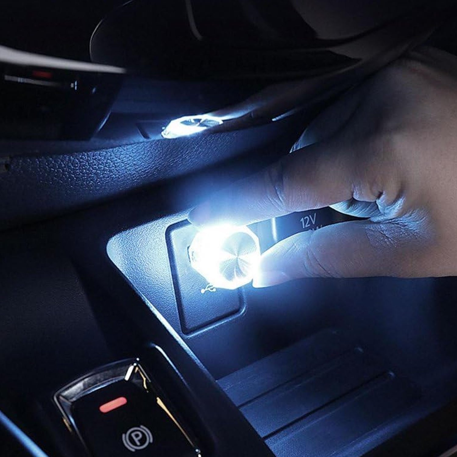 A hand holding the colorful diamond-shaped USB LED light for car and home use.