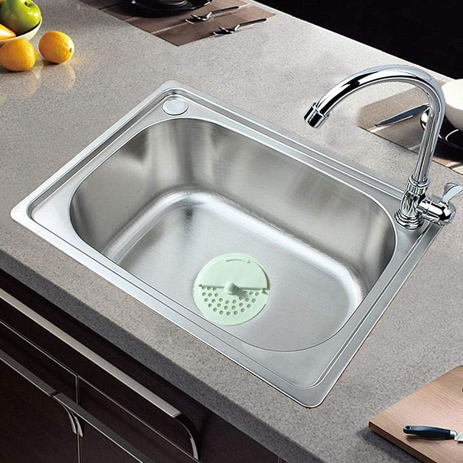 Silicone drain cover effectively blocking odors and hair in a kitchen sink.
