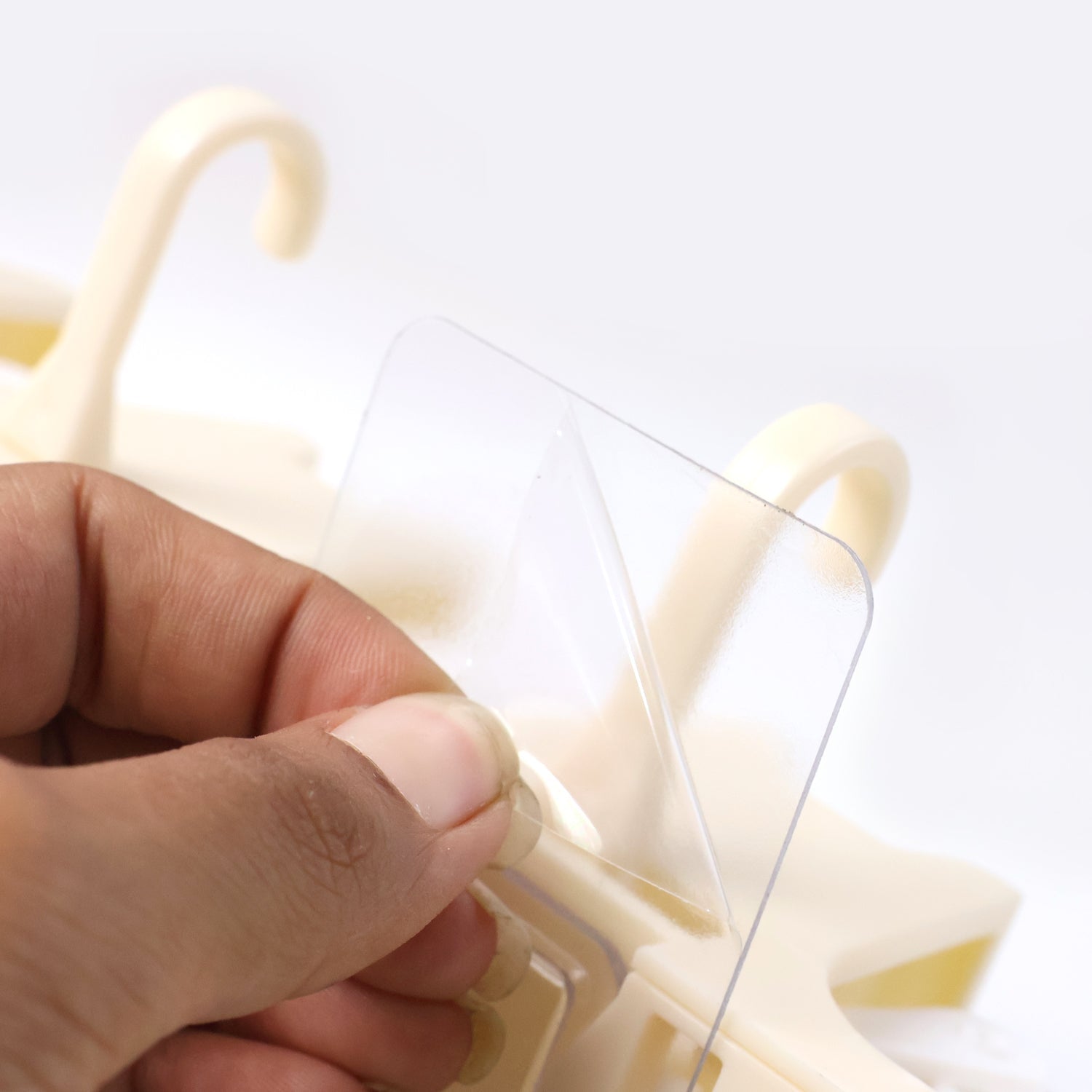 Cleaning tools organized on wall-mounted self-adhesive holder rack