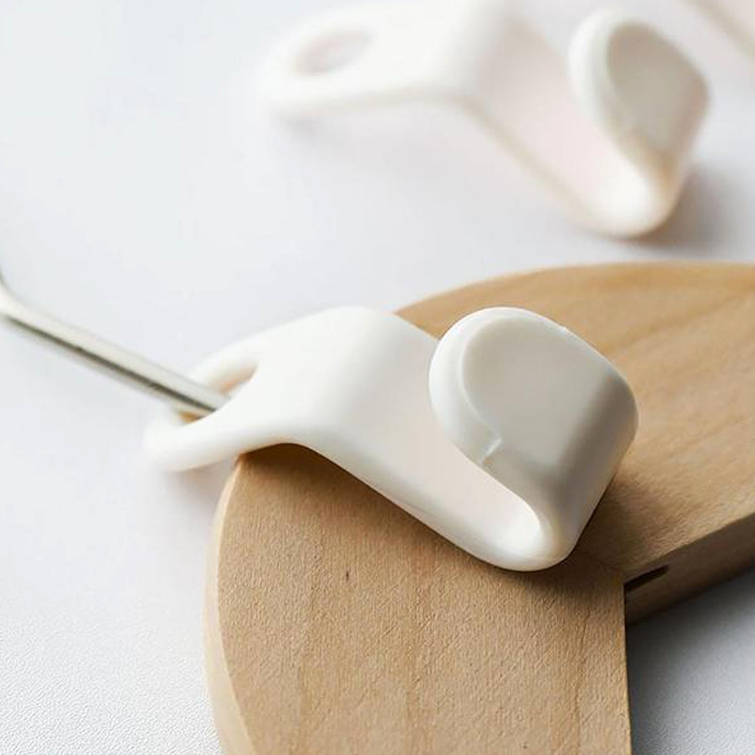 White hanger connector hooks in use, creating a space-saving cascade in a wardrobe.