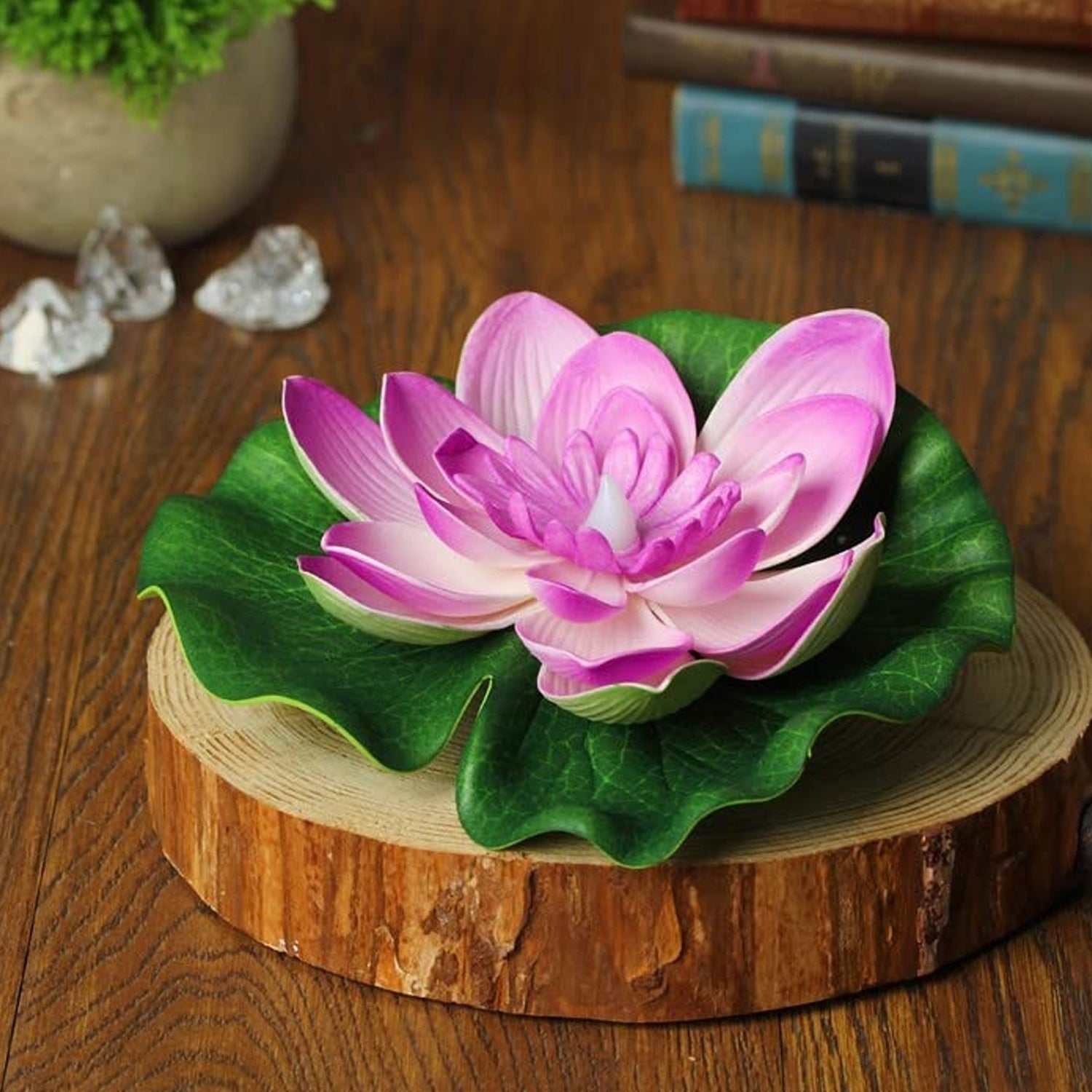 Water-resistant Floating Lotus LED Candles glowing brightly on a pool surface at night.
