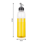 Hand pouring oil from the 1 litre transparent plastic oil dispenser with precise control.