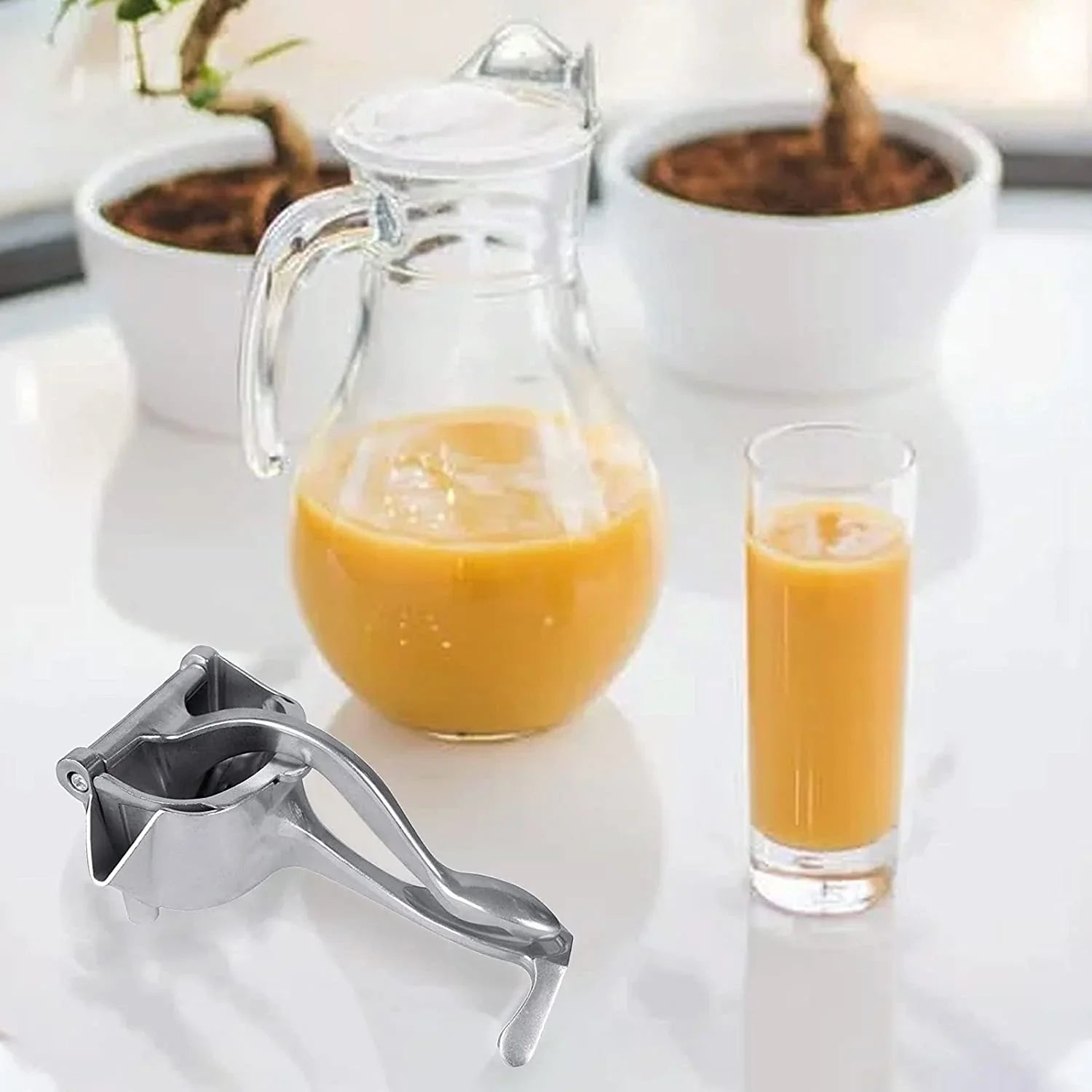 Fresh orange half being pressed in the efficient manual fruit juicer.