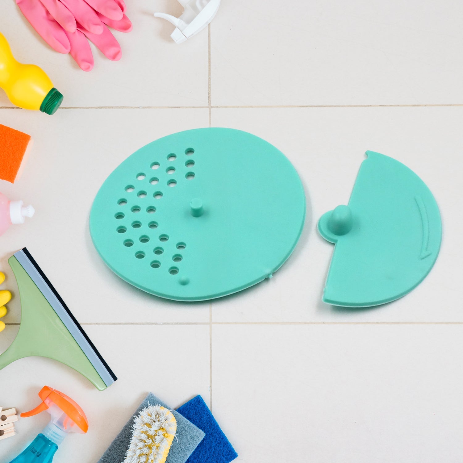 Round rubber anti-odor drain cover in a bathroom shower, preventing hair and debris.