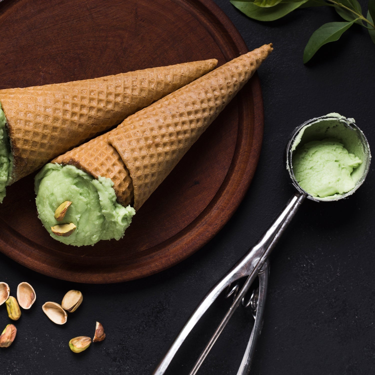 Stainless steel ice cream scoop with an easy-release trigger mechanism.