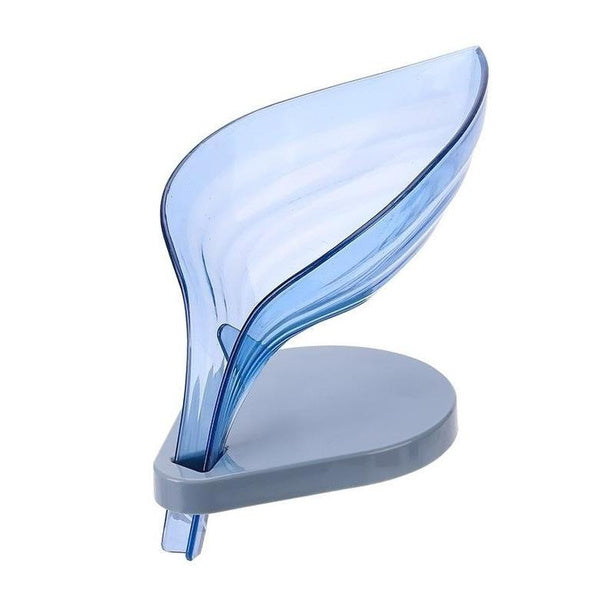 A blue leaf-shaped soap dish in a bathroom setting, demonstrating its draining function.