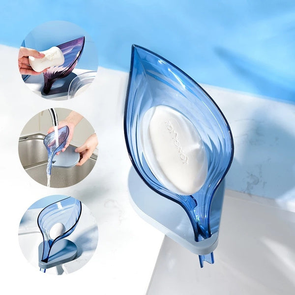 A green self-draining soap dish in a leaf shape, ready for use on a bathroom counter.