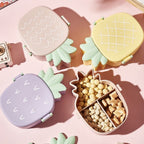 Vibrant pineapple Kids Bento Lunch Box with included fork and spoon.