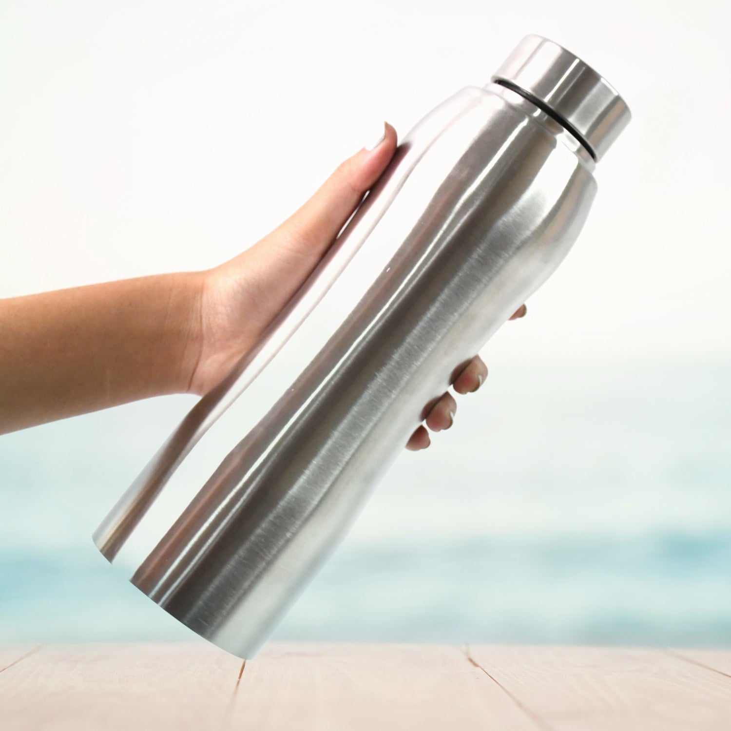 Stainless steel bottle filled with ice cubes demonstrating insulation