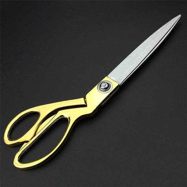 Elegant gold-plated professional tailoring shears for precise fabric cutting.