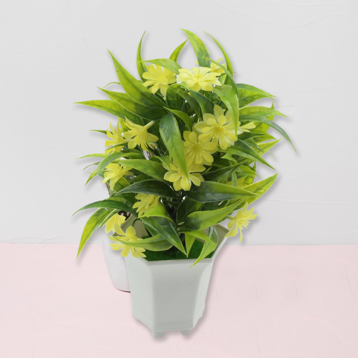 Vibrant artificial yellow flower plant in a minimalist white pot.