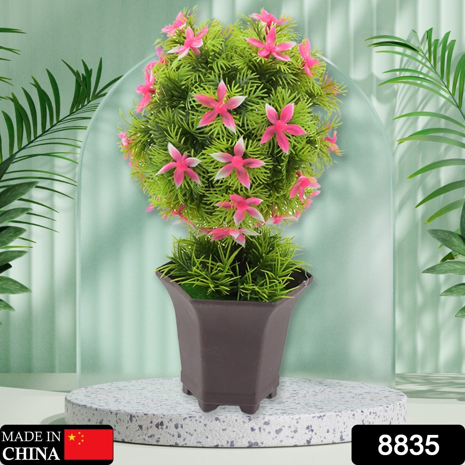 Close-up of the realistic green leaves and delicate flowers of the artificial plant.