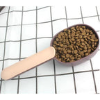 Compact pet food scoop with integrated bag clip for convenient storage.